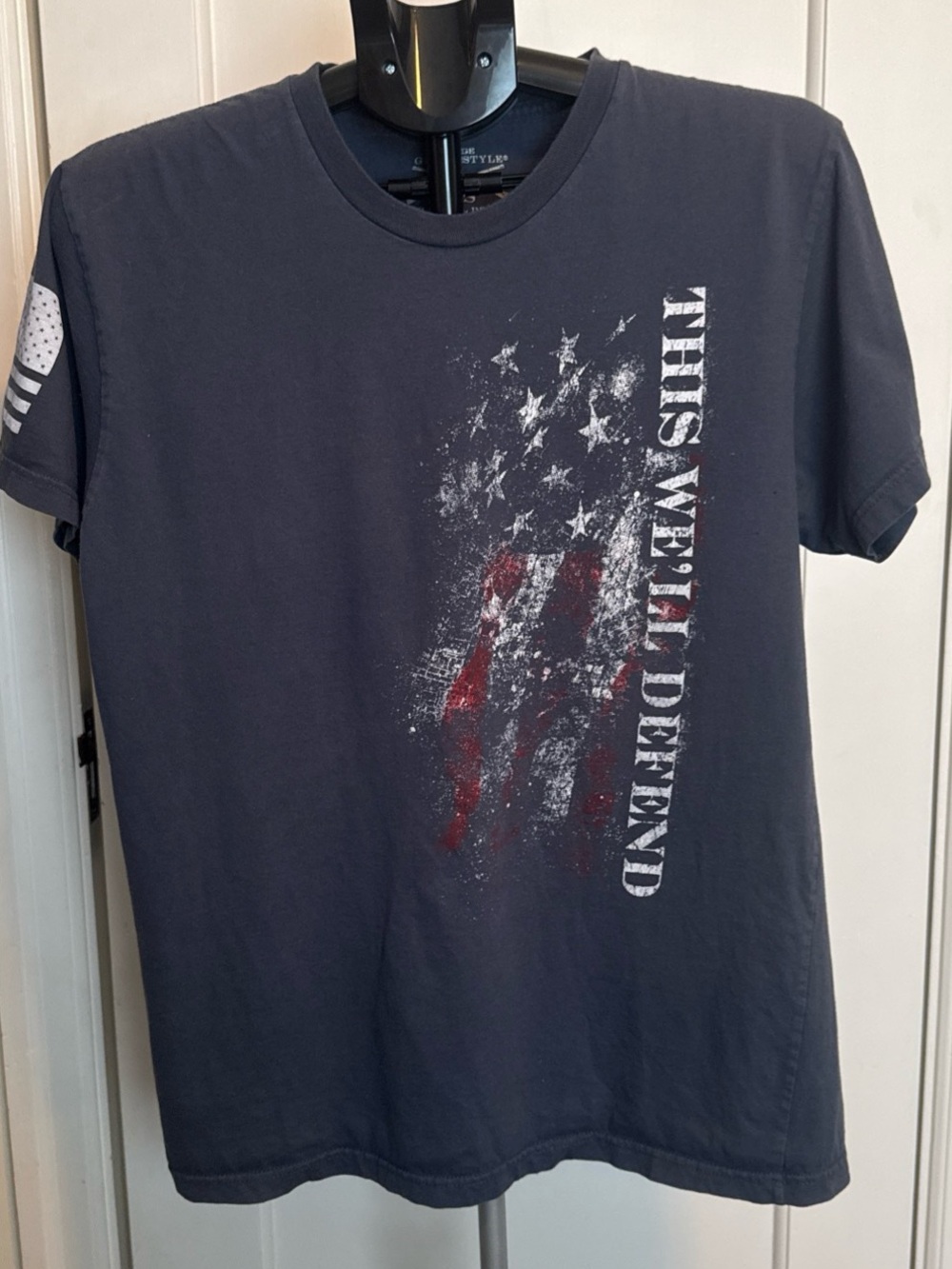 Grunt Style Navy Short Sleeve Tee with Distressed Flag and 'This We'll Defend'